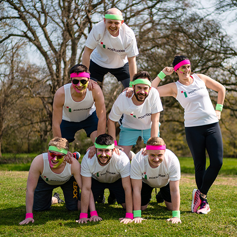 Tough mudder team in a human pyramid